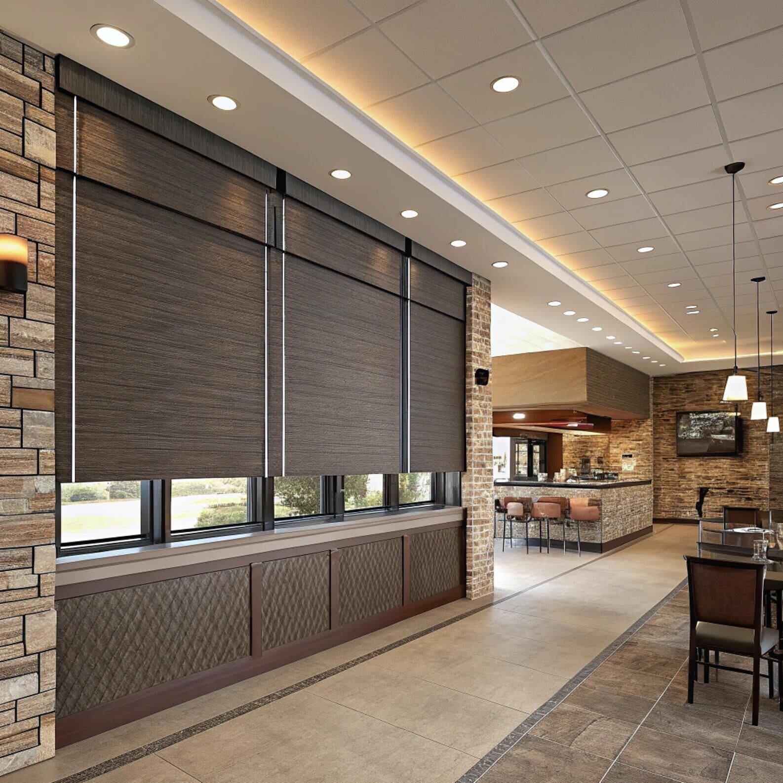 Commercial space with motorized blackout roller shades