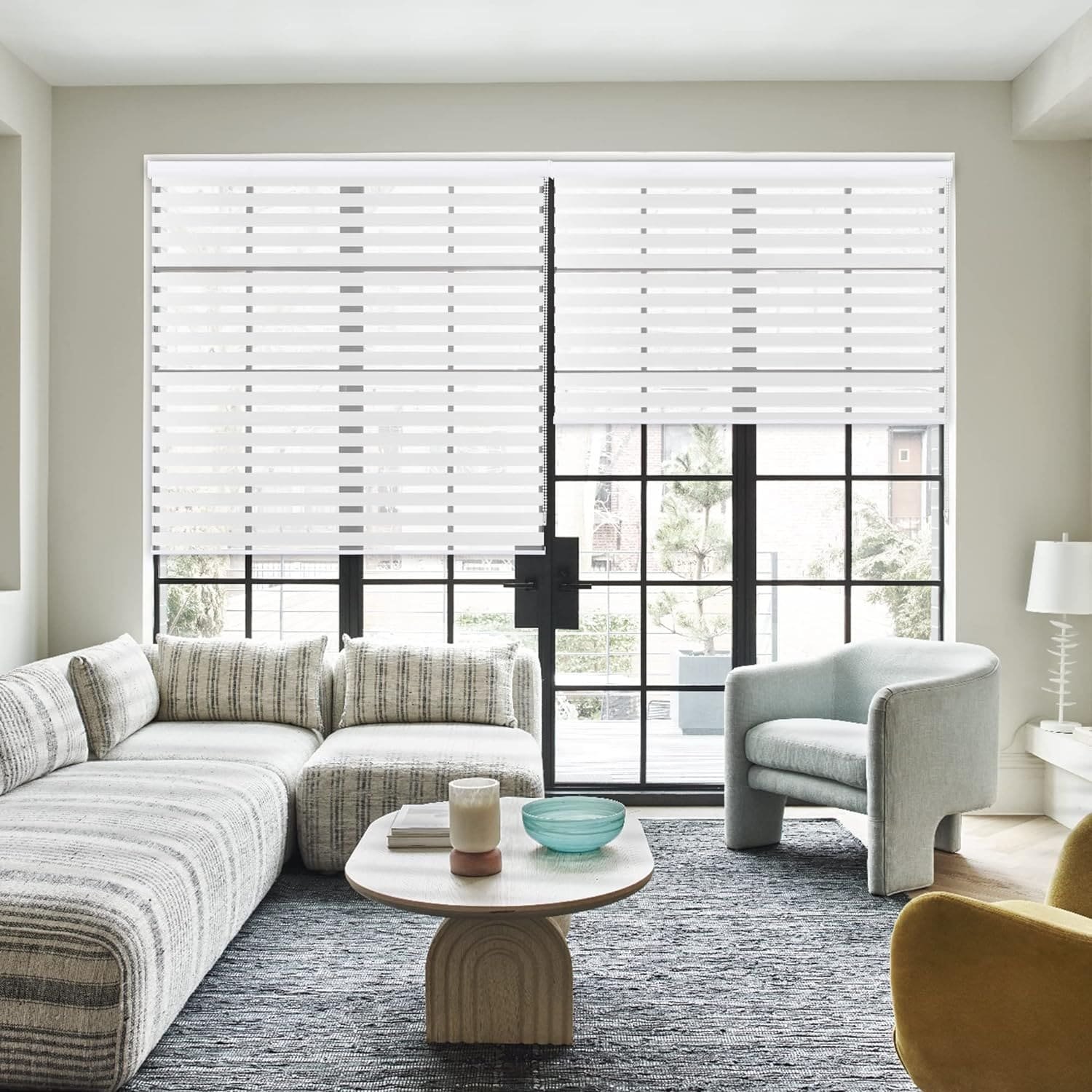 Contemporary living room with [zebra blinds](https://www.zebracustomblinds.ca/blog/hidden-benefits-of-commercial-blinds-for-your-business/)[^3] and modern sofa