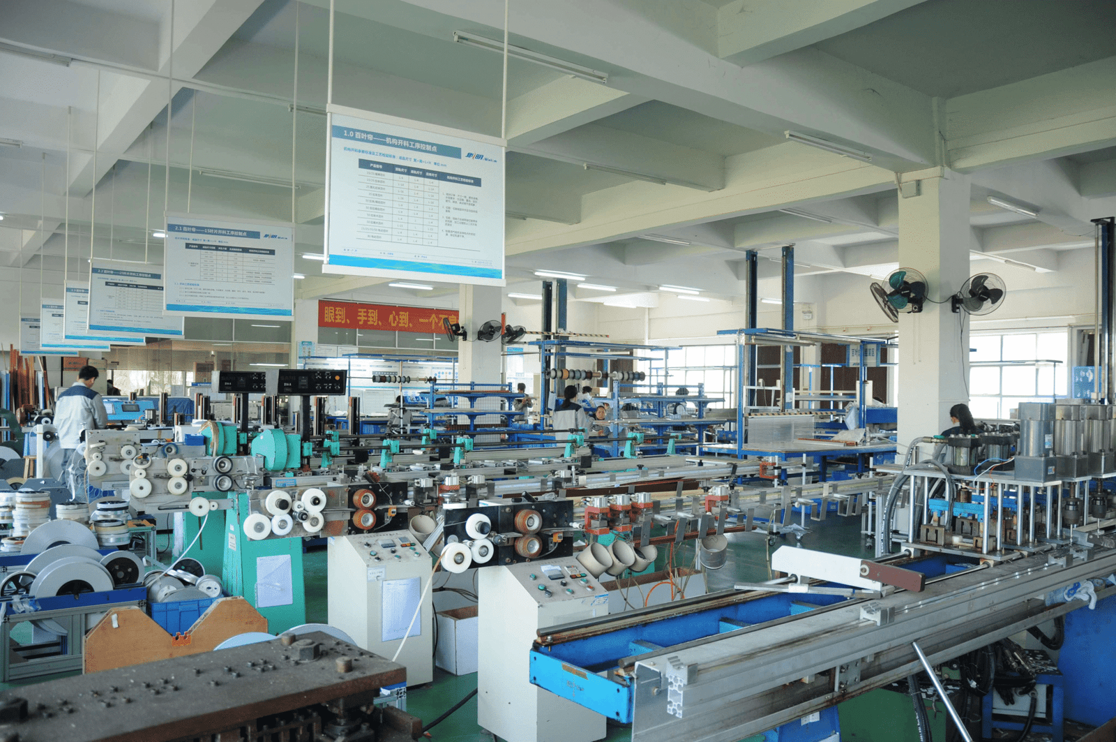 Industrial factory with equipment, workers busy in window treatment production