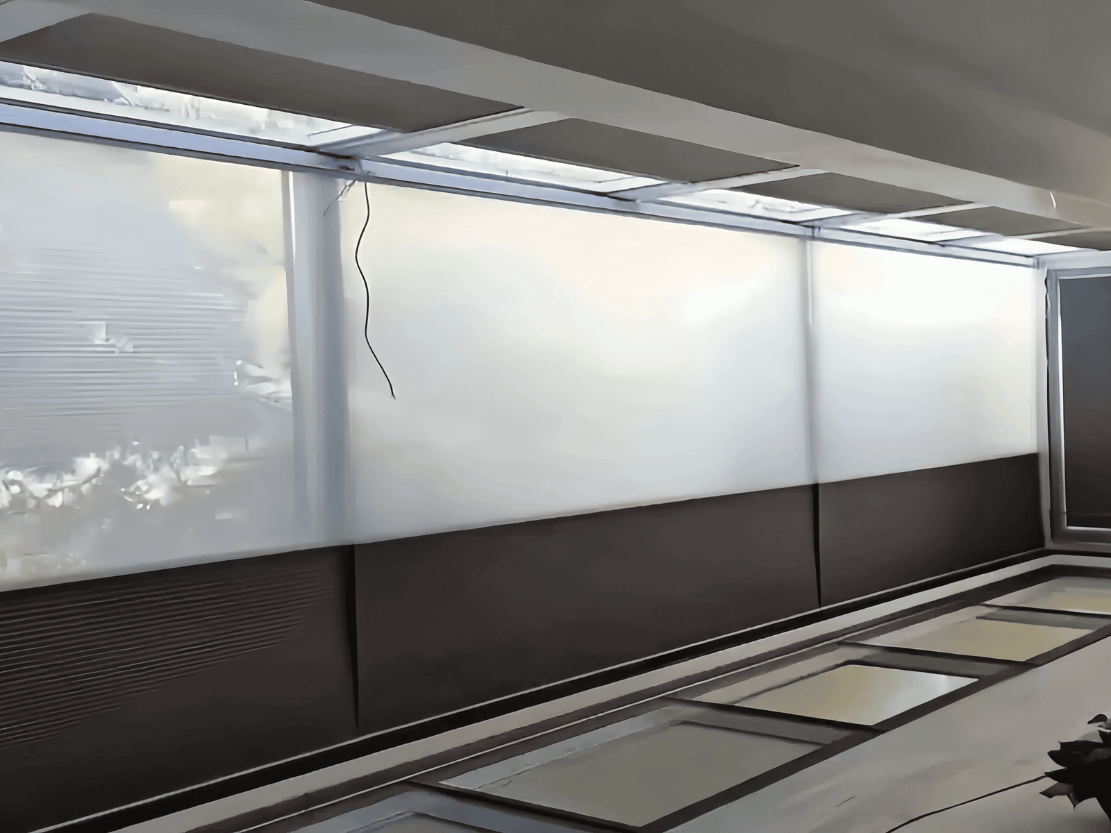 Large windows with frosted roller shades installed