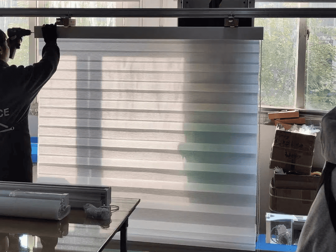 Technician assembling smart blinds, ensuring quality control in process