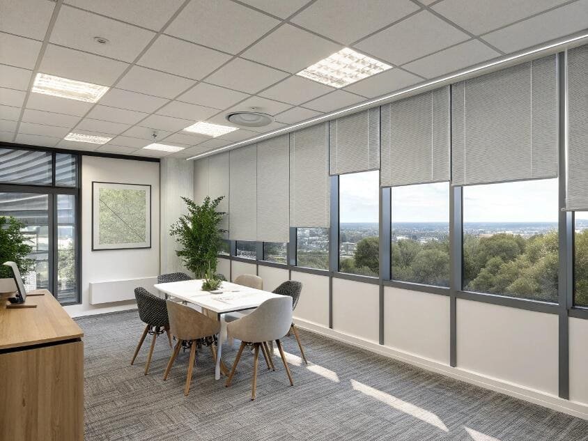 Modern office meeting room with grey pleated window shades and city view