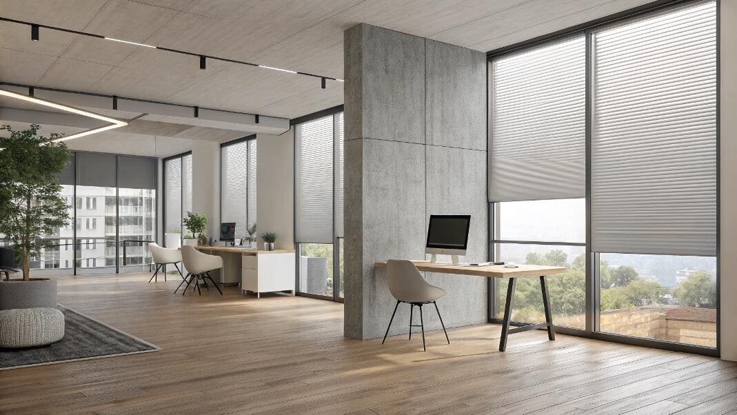 Minimalist open office with smart blinds on tall windows