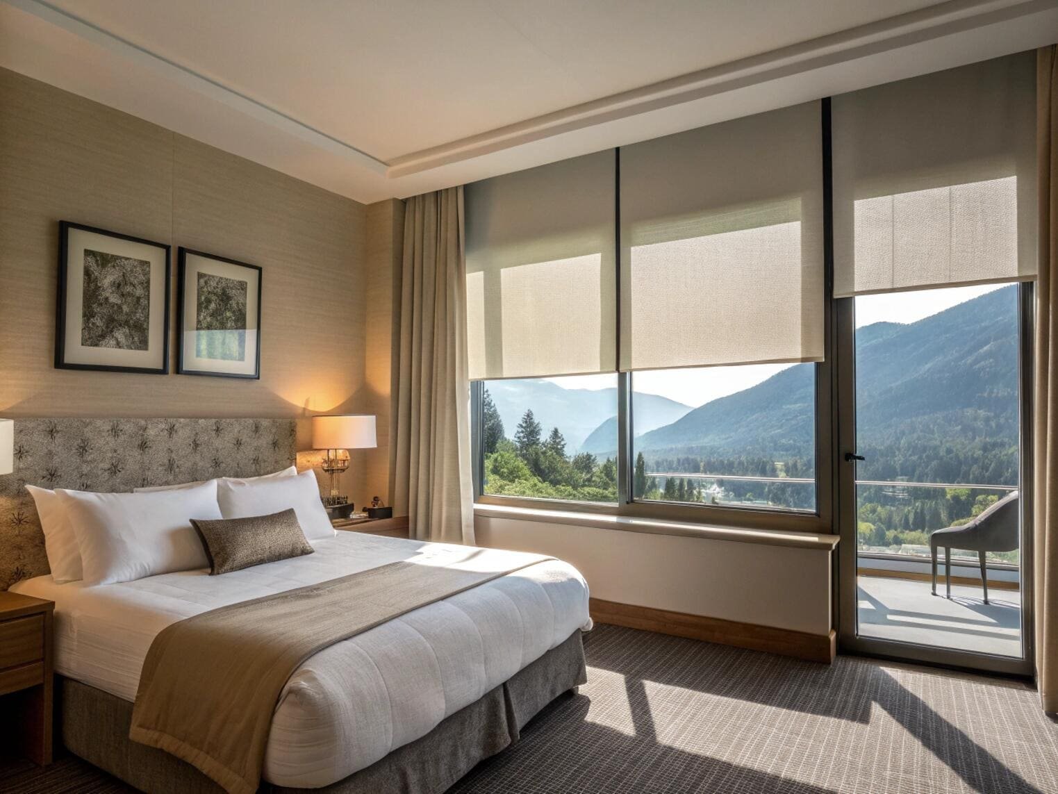Hotel bedroom with mountain view and light-filtering roller shades