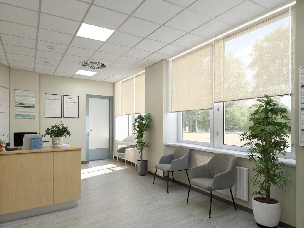 Medical reception area with soft beige roller shades