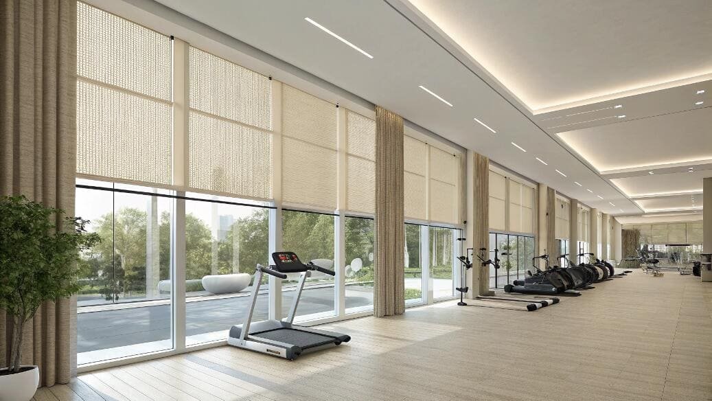 Modern fitness center with large solar roller blinds