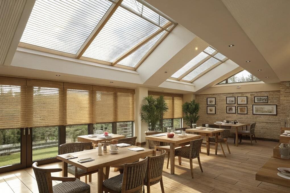 Sunlit café with woven wood window and skylight blinds