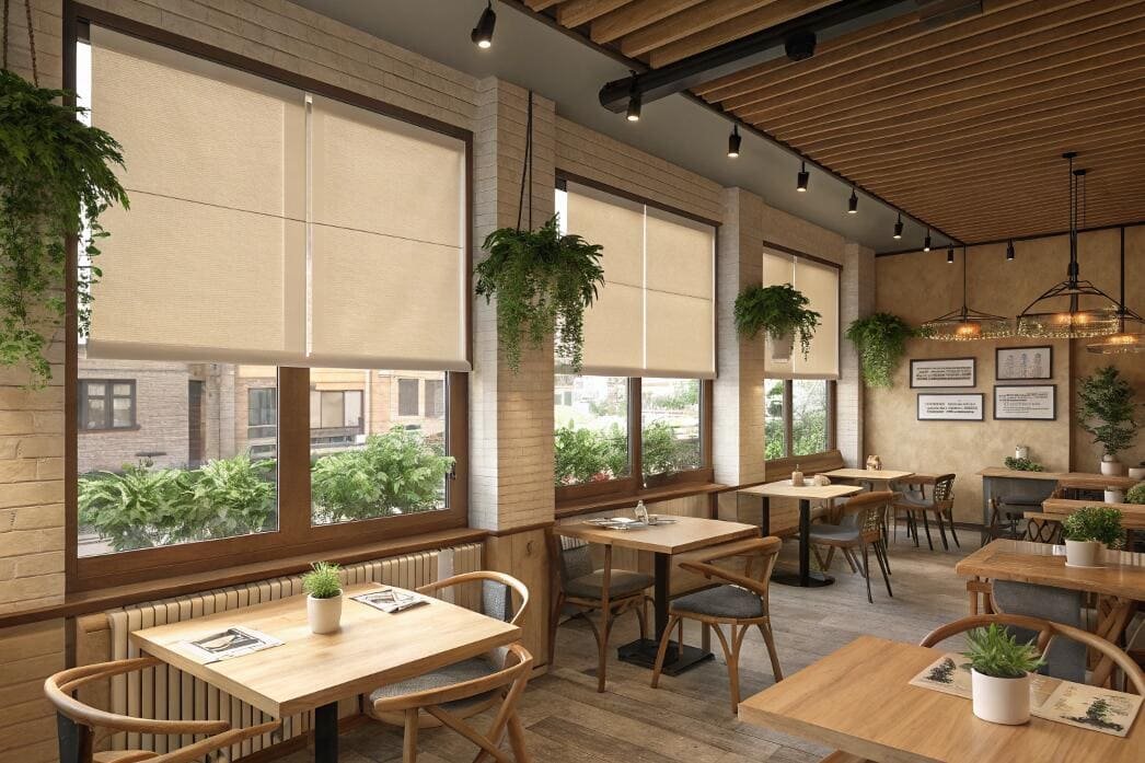 Trendy cafe with beige blackout roller shades