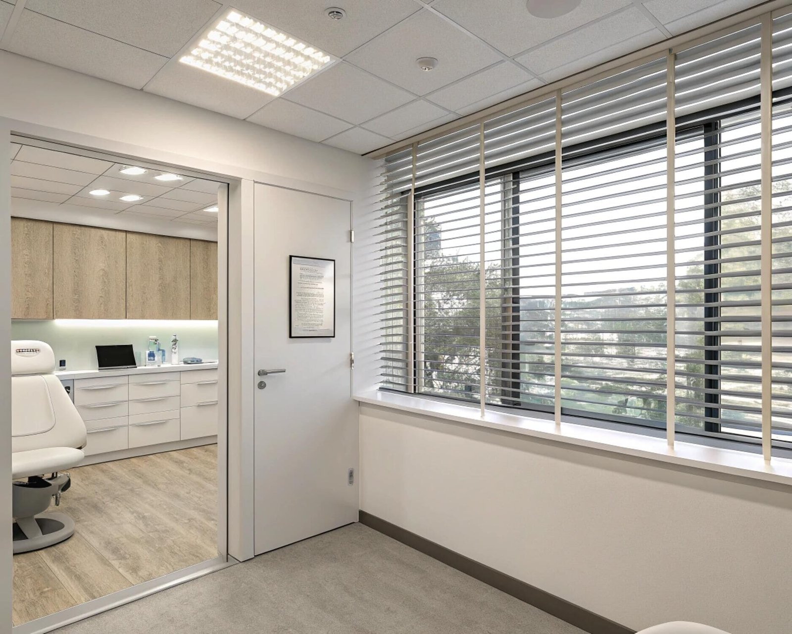 Medical office waiting area with light wood horizontal blinds