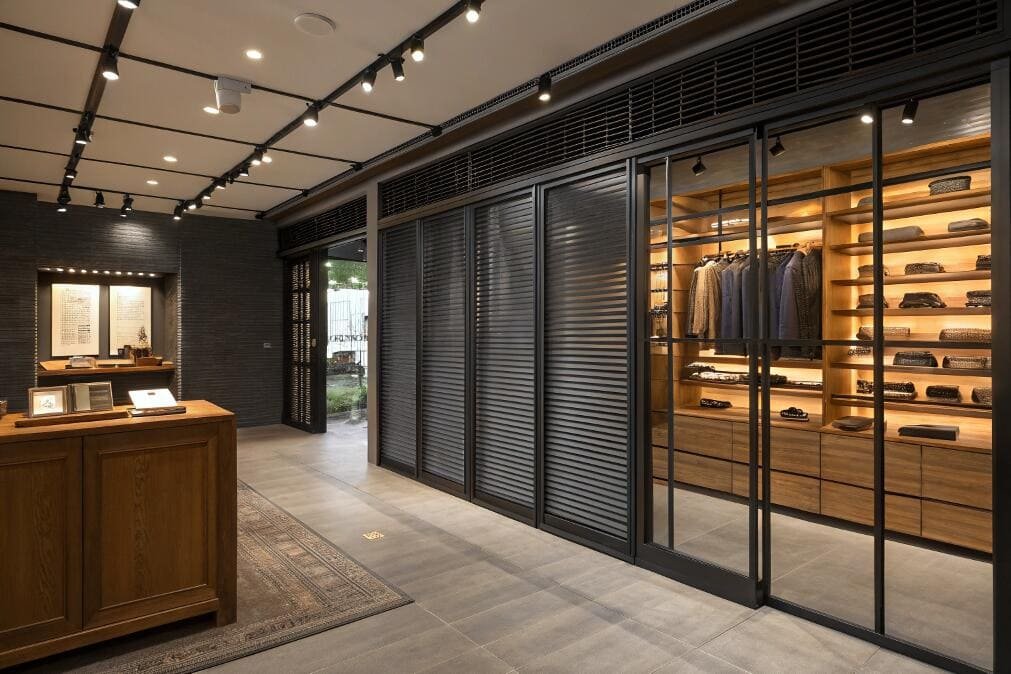 Luxury showroom with dark louvered sliding glass doors