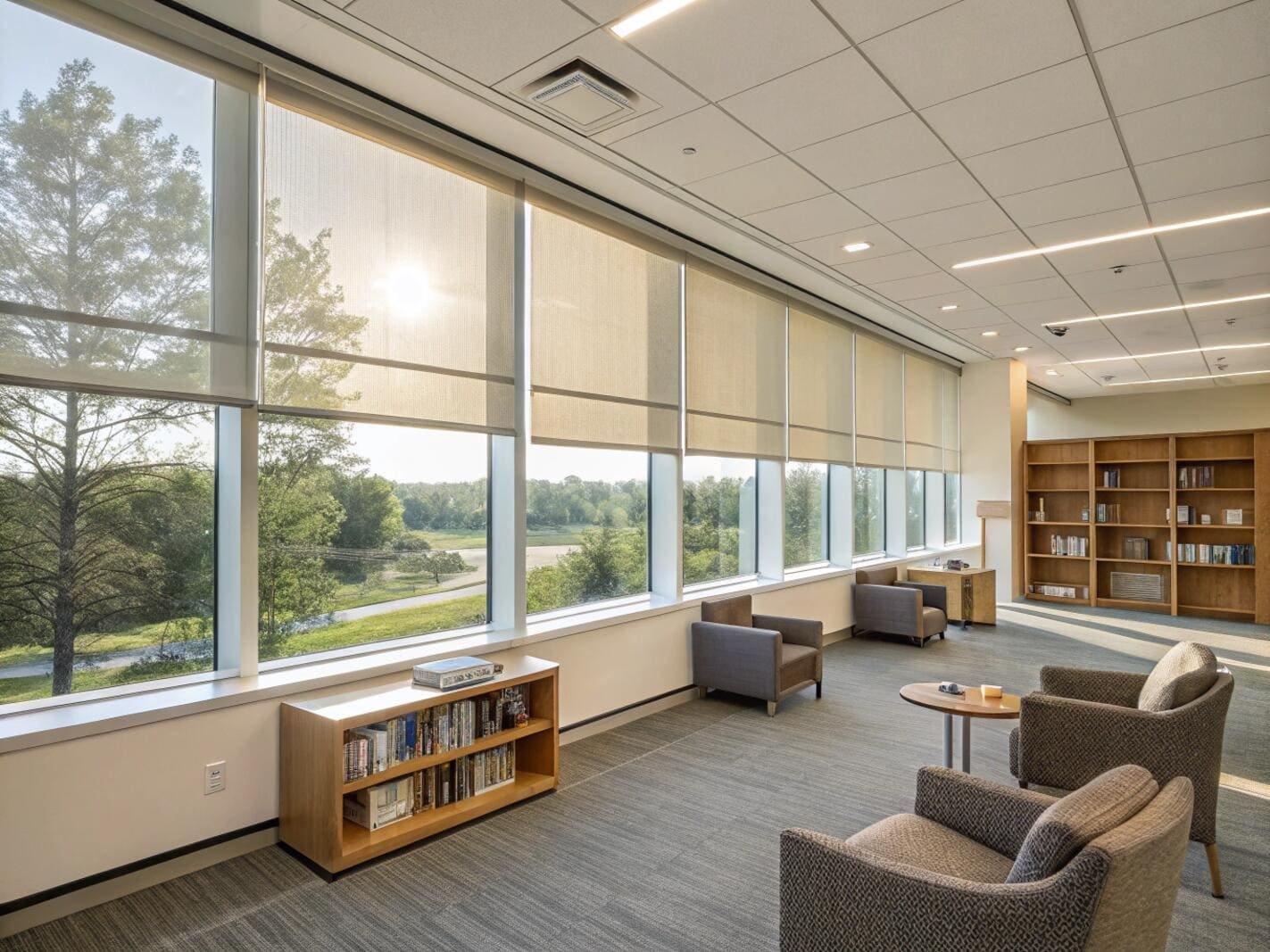 Office lounge area with comfortable seating and light-filtering roller shades