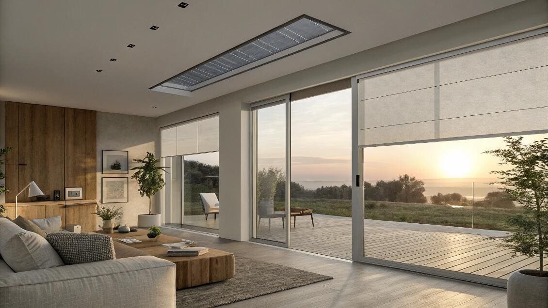 Modern living room with smart roman shades and skylight shades overlooking a scenic view.