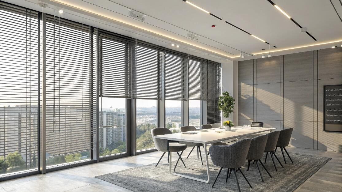 Modern meeting room with large windows fitted with dark gray horizontal blinds.