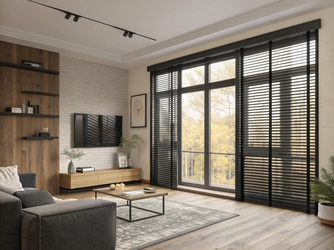 Modern living room featuring bold black wood blinds on large sliding glass doors.