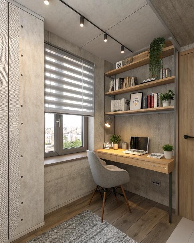 Compact home office with a minimalist desk and window featuring practical striped zebra blinds.