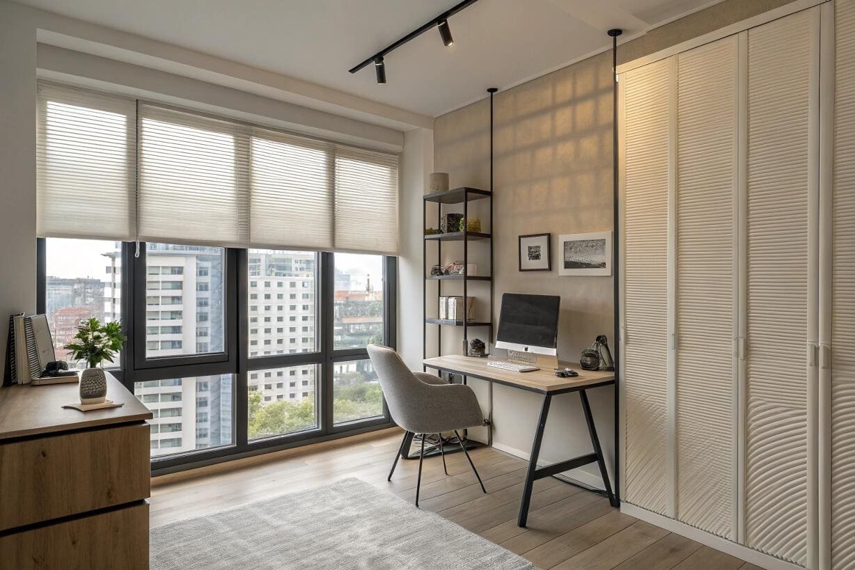 Urban home office with city view and light-filtering pleated window shades.