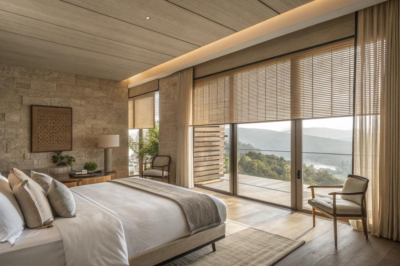Luxurious bedroom with panoramic mountain view and woven wood blinds.