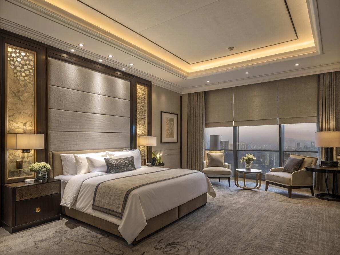Luxury hotel bedroom featuring motorized dual shades for versatile light and blackout control.