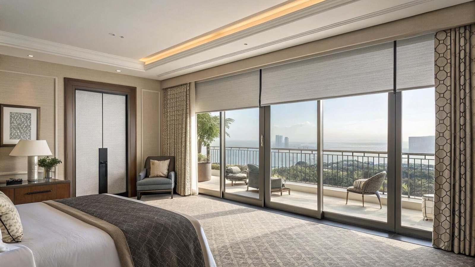 Light-filtering roller shades span large sliding doors in a luxury waterfront bedroom.