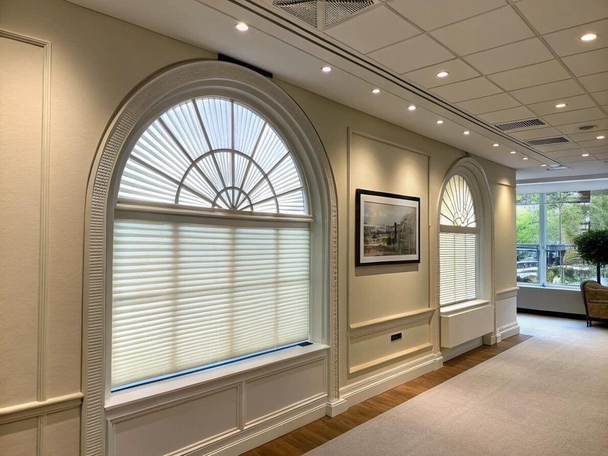 Custom arched cellular shades providing an elegant solution for special architectural windows.