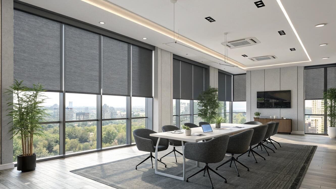 Modern conference room featuring black roller shades & full cityscape.