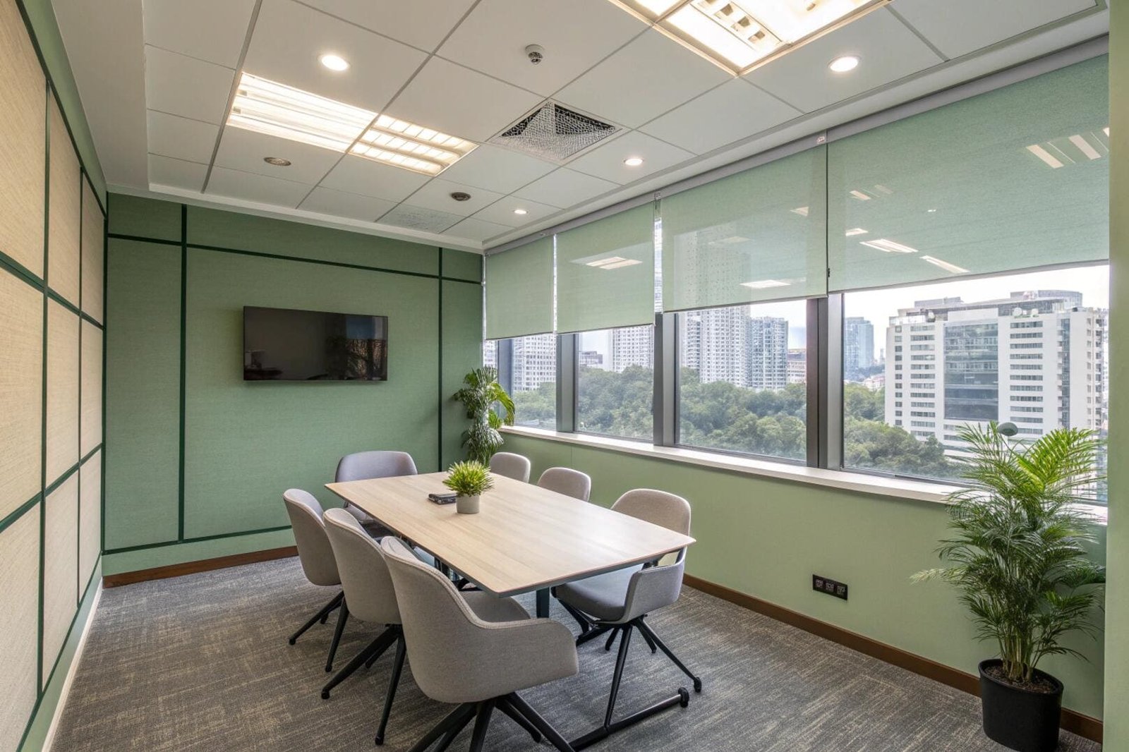 Solar roller shades reduce glare and heat in a modern office conference room.