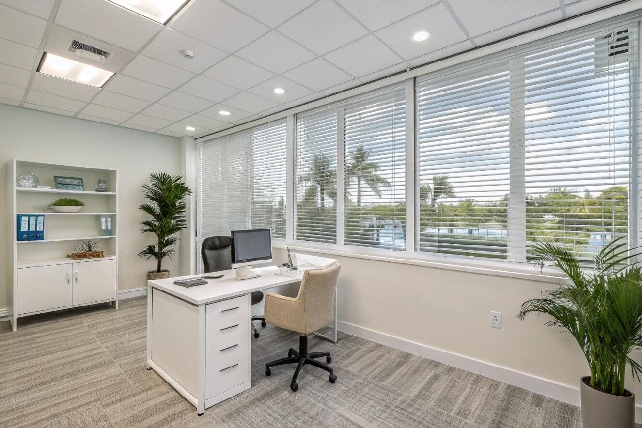 Well-lit office featuring venetian blinds offering privacy.