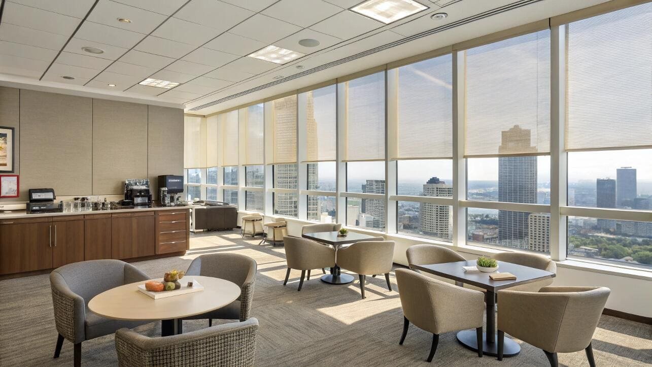 Corporate break room with privacy shades and city ambiance.