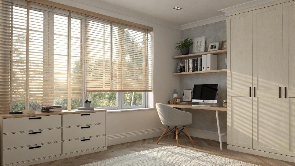 Bright home office with light wood furniture and natural wood horizontal blinds.
