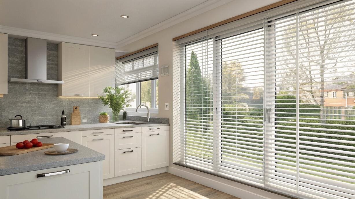 Durable white venetian blinds offer clean light control for modern kitchen patio doors.