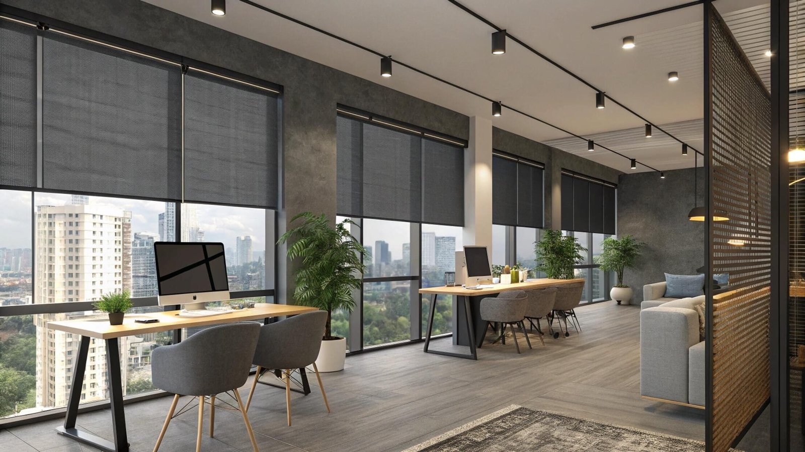 Dark solar shades reduce glare in a modern open-plan office with a city view.