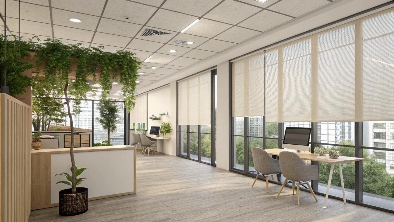 Cellular shades enhance the natural light in a biophilic-designed office reception area.